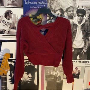 red cropped sweater with open section in back